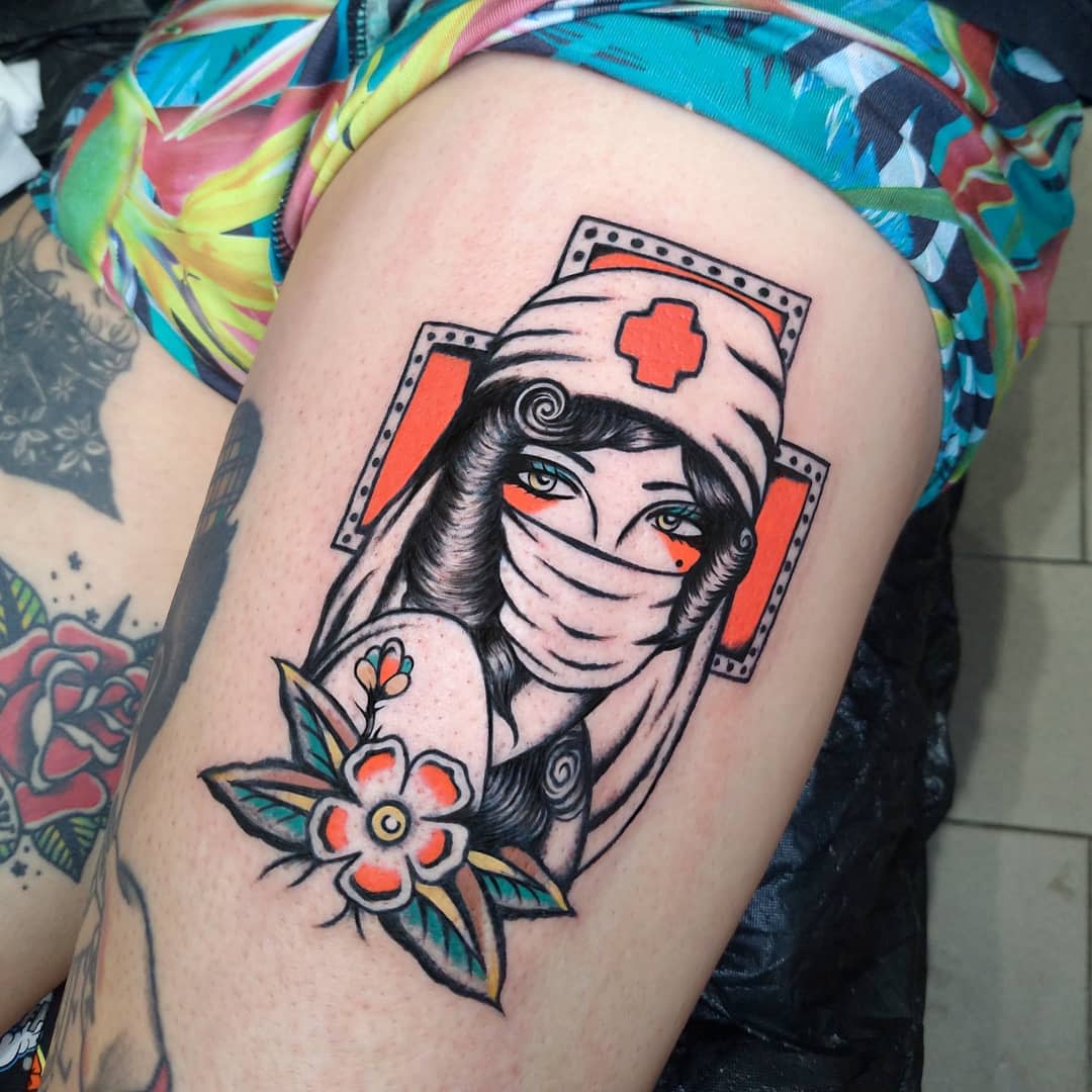 Tattoo of a veiled nurse with flowers on the thigh, featuring vintage style and vibrant colors